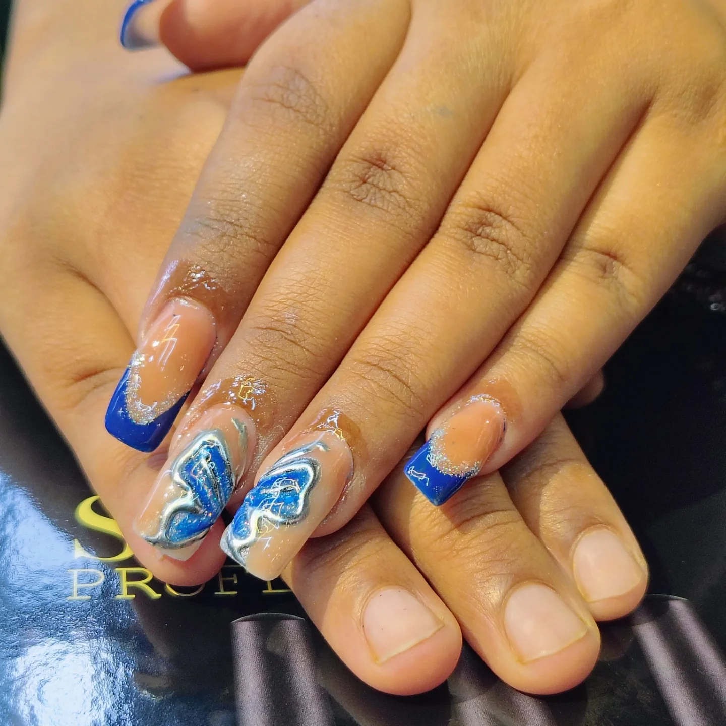 Beautiful blue nail art with butterfly designs created at Music Salon Mandi HP